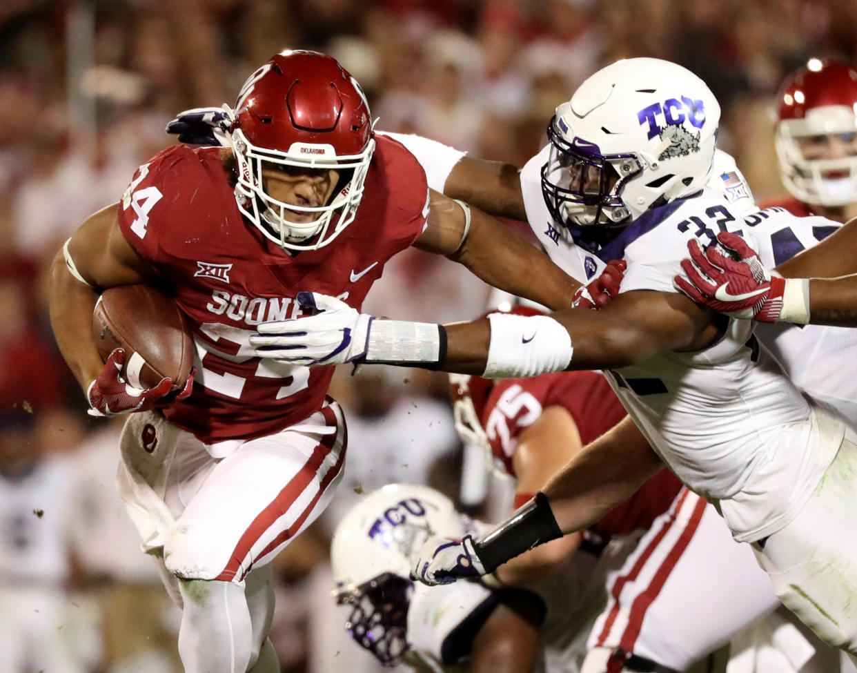 Nov 11, 2017; Norman, OK, USA; Oklahoma Sooners running back Rodney Anderson (24) runs as TCU Horned Frogs linebacker Travin Howard (32) defends during the first half at Gaylord Family – Oklahoma Memorial Stadium. Mandatory Credit: Kevin Jairaj-USA TODAY Sports TPX IMAGES OF THE DAY