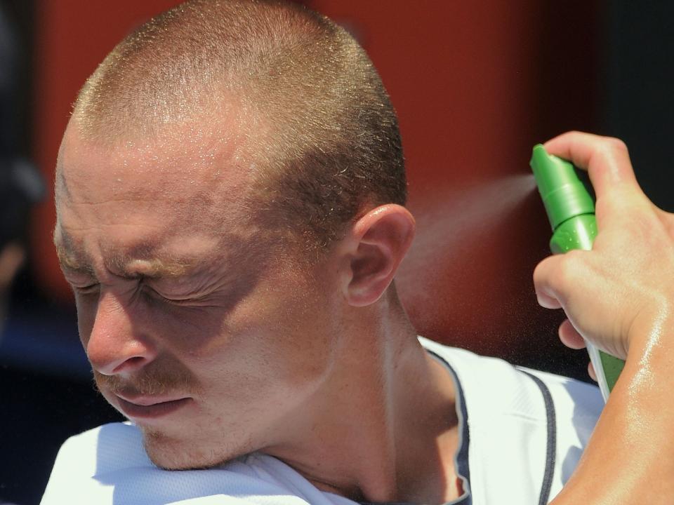 Brandon Inge of the Detroit Tigers sprays sunscreen on his neck.