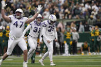 TCU place kicker Griffin Kell (39) celebrates with teammates Jake Boozer (47) and Jordy Sandy (31) after hitting a field goal in the final seconds of an NCAA college football game against Bayor in Waco, Texas, Saturday, Nov. 19, 2022. TCU won 29-28. (AP Photo/LM Otero)