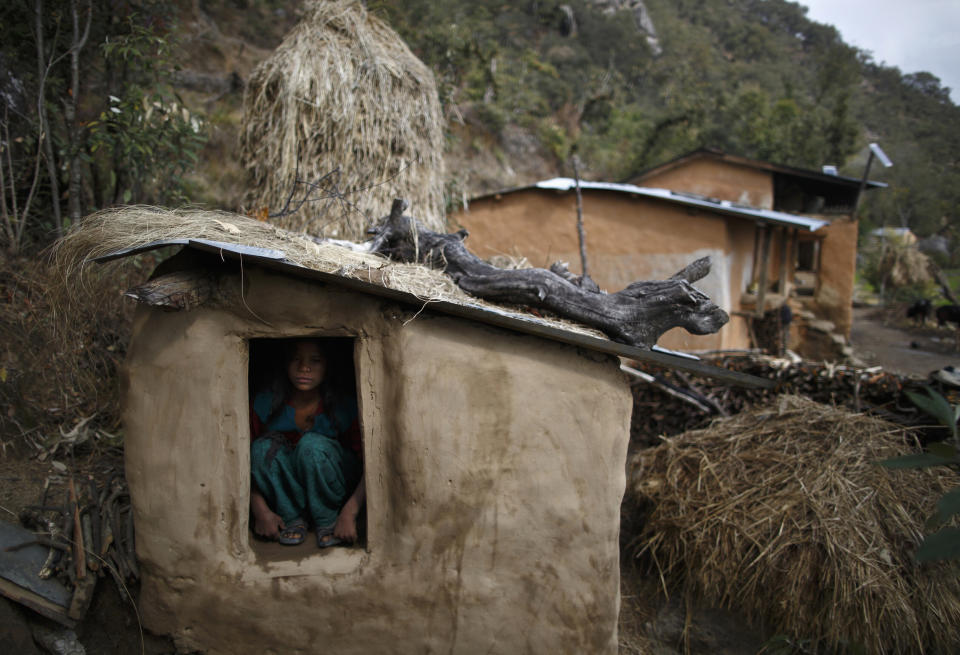 A 14-year-old girl sits inside a chhaupadi shed in the hills of Legudsen village in Achham district in western Nepal in 2014. (Photo: Navesh Chitrakar/Reuters)