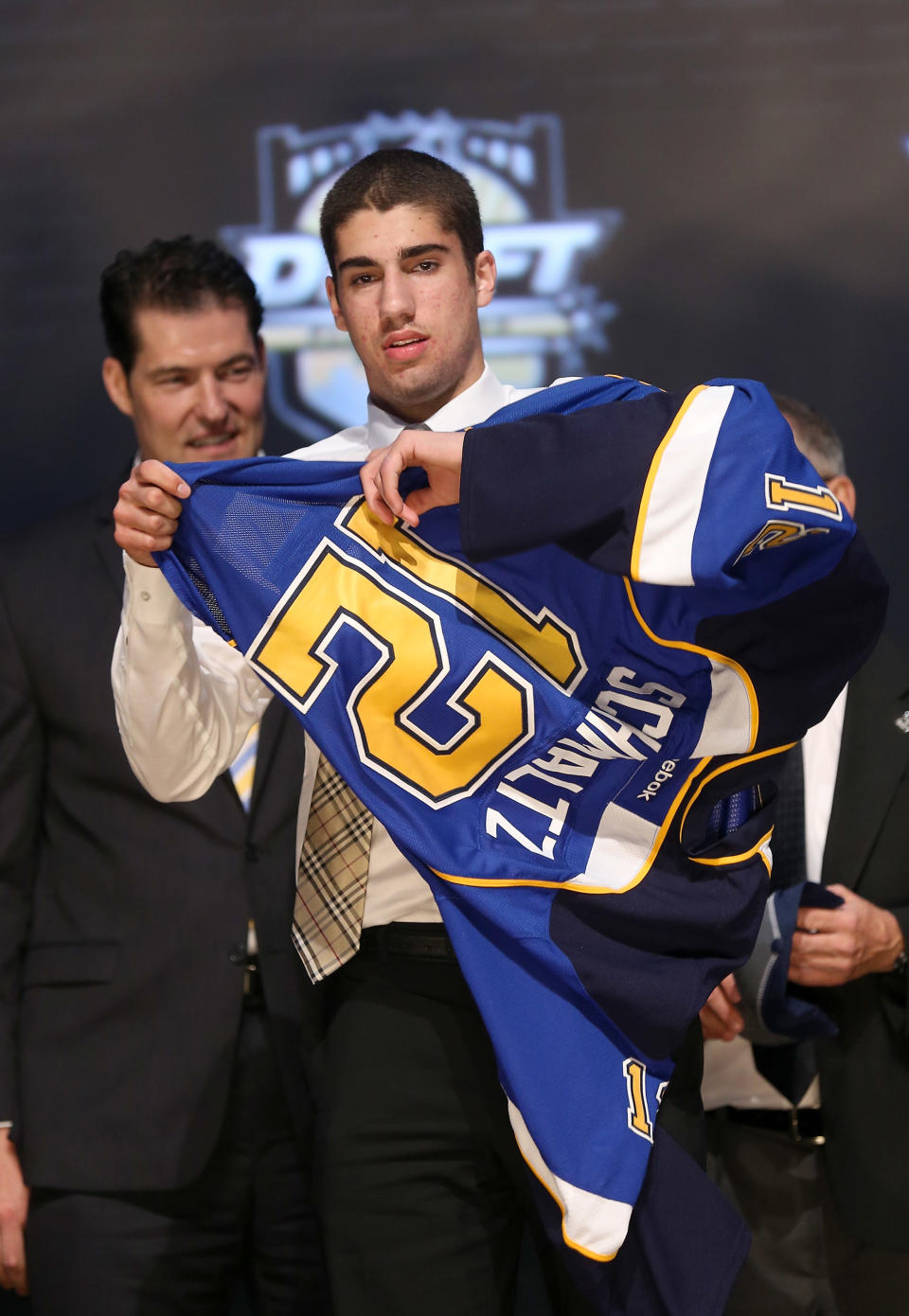 PITTSBURGH, PA - JUNE 22: Jordan Schmaltz, 25th overall pick by the St. Louis Blues, puts on a jersey on stage during Round One of the 2012 NHL Entry Draft at Consol Energy Center on June 22, 2012 in Pittsburgh, Pennsylvania. (Photo by Bruce Bennett/Getty Images)