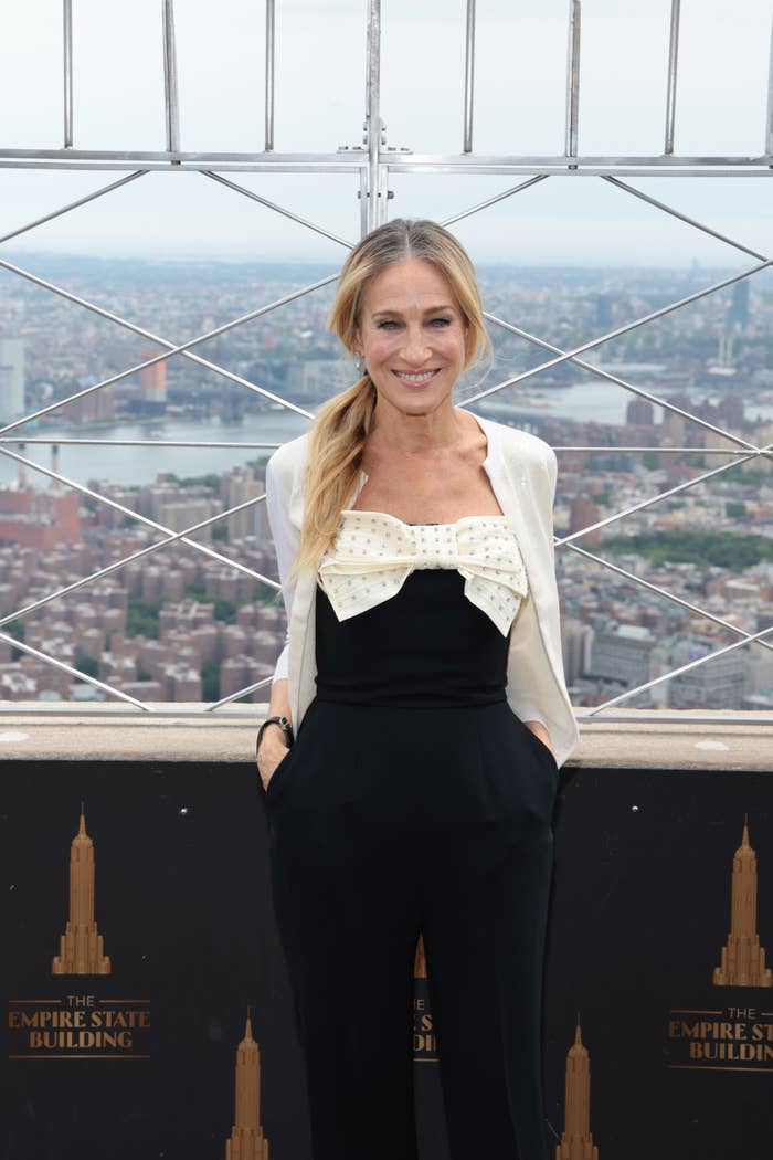 closeup of her on top of the empire state building