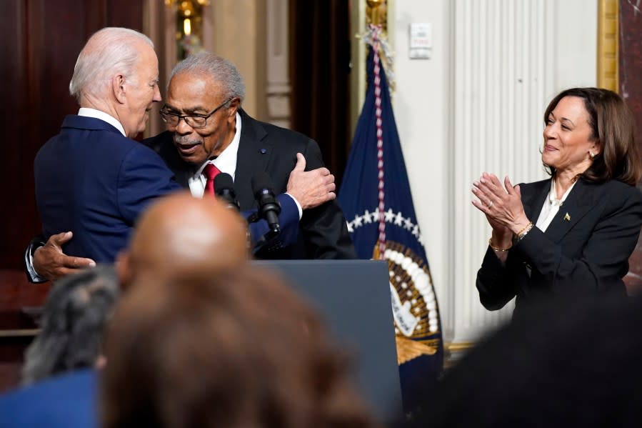 President Joe Biden hugs Rev. Wheeler Parker, Jr., as Vice President Kamala Harris applauds, at an event to establish the Emmett Till and Mamie Till-Mobley National Monument, in the Indian Treaty Room in the Eisenhower Executive Office Building on the White House campus, Tuesday, July 25, 2023, in Washington. (AP Photo/Evan Vucci)