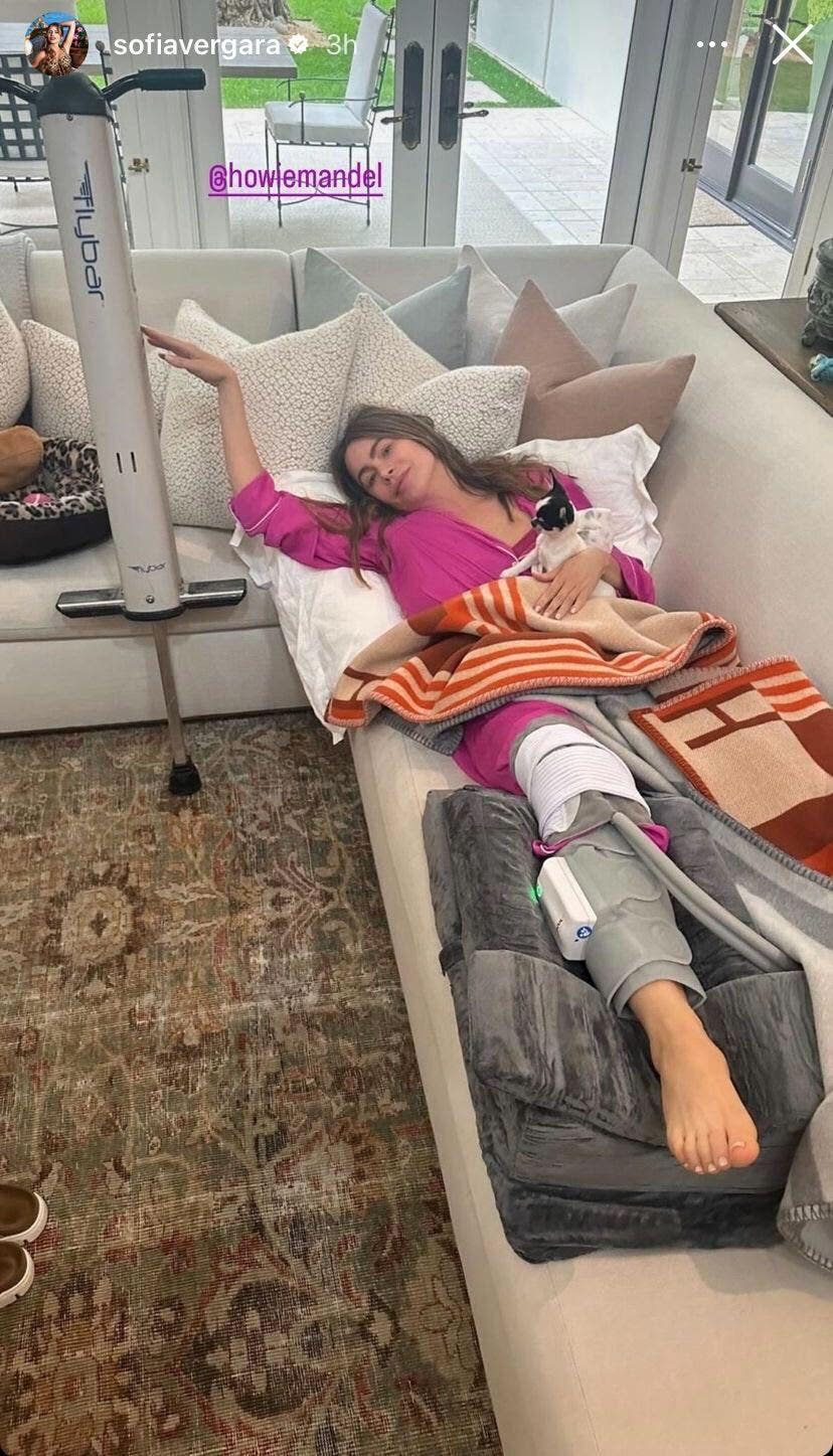 sofia vergara laying on couch with knee brace