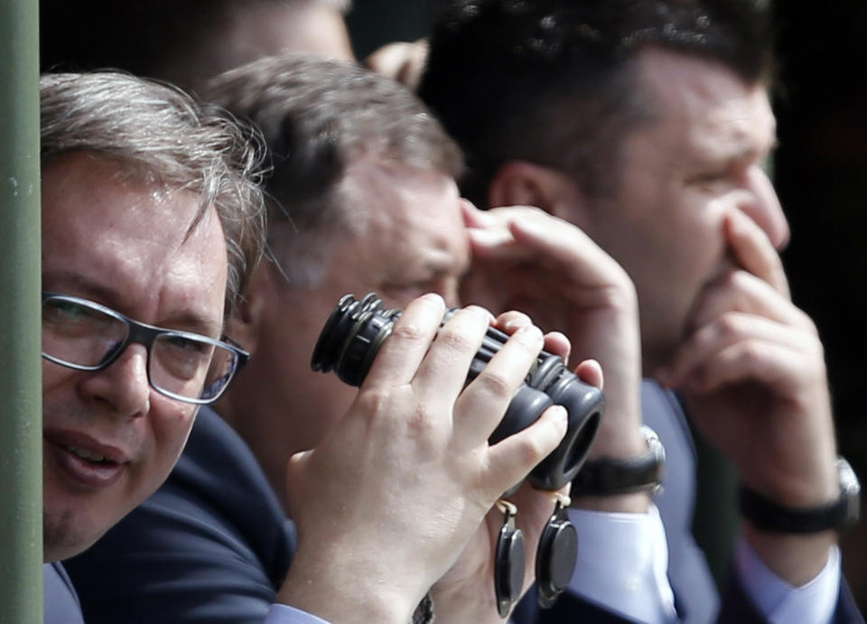 FILE In this Tuesday, May 9, 2017 file photo, Serbian President Aleksandar Vucic, left, watches exercise at a ceremony marking 72 years since the end of WWII and the defeat of Nazi Germany, at Nikinci training ground, 60 kilometers west of Belgrade, Serbia. Serbia will continue to strengthen its armed forces and is ready to purchase more warplanes amid simmering tensions in the Balkans, the Serbian president said Sunday, July 26, 2020. (AP Photo/Darko Vojinovic, file)