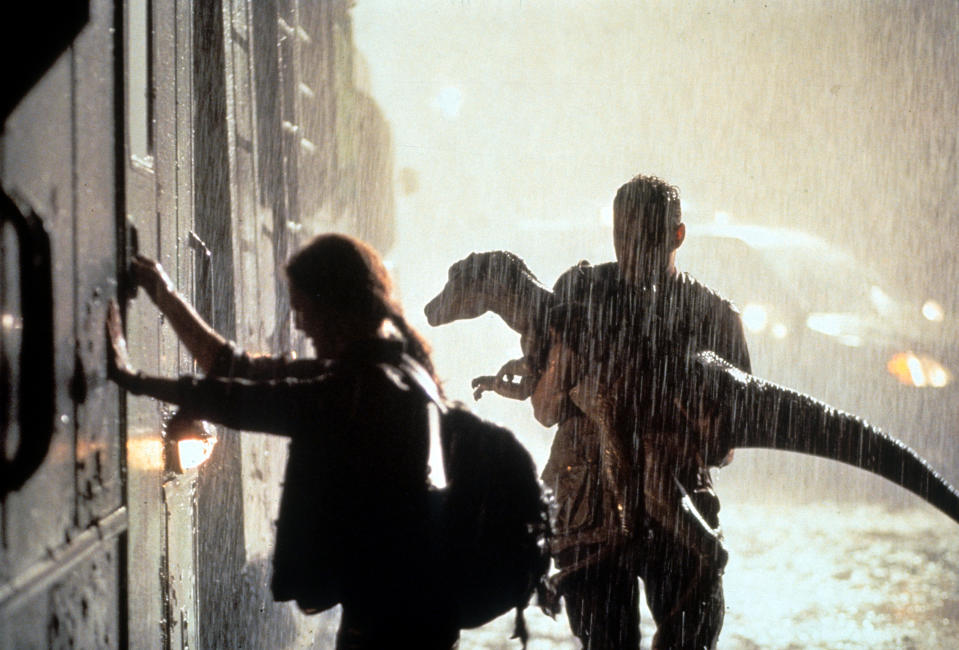 Julianne Moore grabbing the door of a train as Vince Vaughn holds a small dinosaur in a scene from the film 'The Lost World: Jurassic Park', 1997. (Photo by Universal Pictures/Getty Images)