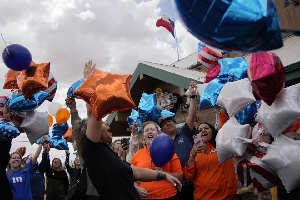 People release balloons during a memorial for Jackson Zinn at a Texas Roadhouse restaurant, Thursday, March 17, 2022, in Hobbs, New Mexico. Zinn, who worked at the restaurant, was killed with several other student golfers and the coach of University of the Southwest in a crash in Texas. (AP Photo/John Locher)