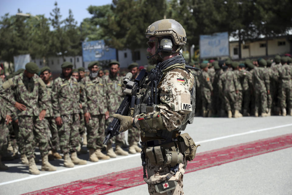 FILE- In this Wednesday, July 10, 2019 file photo, a German soldier with NATO forces stands guard during the graduation ceremony of newly Afghan National Army soldiers after a 3-month training program at the Afghan Military Academy in Kabul, Afghanistan. (AP Photo/Rahmat Gul, File)