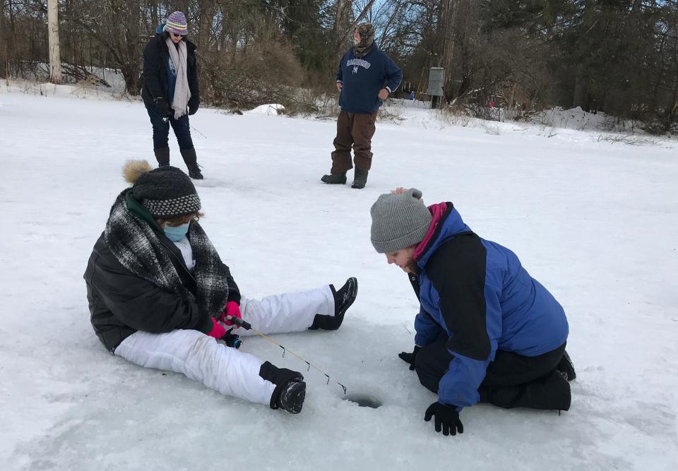 Amelia Pierce, left, and Josephine Pierce of Earlville wait patiently for a nibble on their fishing line in this file photo at Rogers Environmental Education Center in Sherburne. Ice fishing was one of many events during Friends of Rogers' annual Winter Living Celebration.