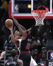 Milwaukee Bucks' Giannis Antetokounmpo drives to the basket under pressure from Chicago Bulls' Coby White (0) during the first half of an NBA basketball game Thursday, Feb. 16, 2023, in Chicago. (AP Photo/Charles Rex Arbogast)