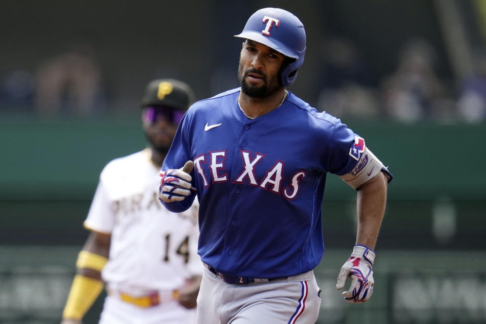 Texas Rangers' Marcus Semien, right, rounds second after hitting a solo home run off Pittsburgh Pirates starting pitcher Johan Ovieto during the first inning of a baseball game in Pittsburgh, Wednesday, May 24, 2023. (AP Photo/Gene J. Puskar)