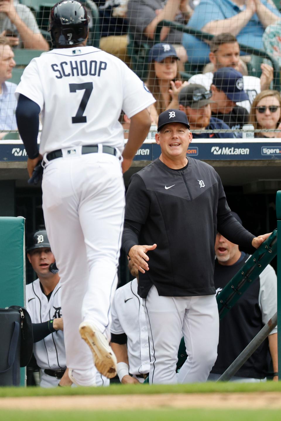 Tigers second baseman Jonathan Schoop (7) is greeted by manager A.J. Hinch after scoring in the second inning May 14, 2022 against the Orioles at Comerica Park in Detroit.