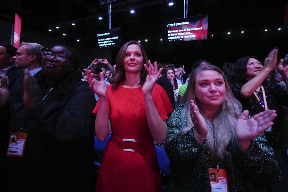 Victoria Starmer, wife of the Britain's opposition Labour Party leader Keir Starmer applauds after an identified man jumped on the stage, at the Labour Party conference in Liverpool, England, Tuesday, Oct. 10, 2023.(AP Photo/Jon Super)