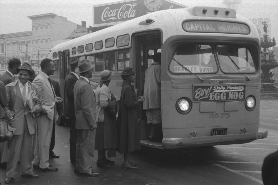 African Americans boarding an integrated bus through the once-forbidden front door, following a Supreme Court ruling ending a successful 381-day boycott of segregated buses.