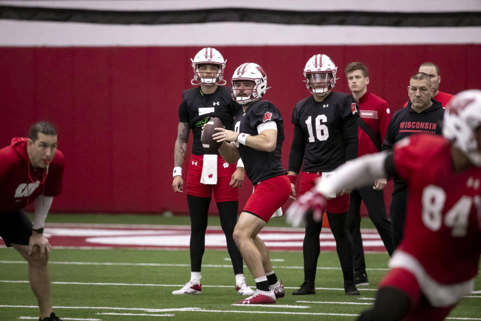 Wisconsin quarterback Tanner Mordecai (8) looks to pass as Nick Evers (7) and Myles Burkett (16) watch during spring NCAA college football practice, Saturday, March 25, 2023, in Madison, Wis. (Samantha Madar/Wisconsin State Journal via AP)