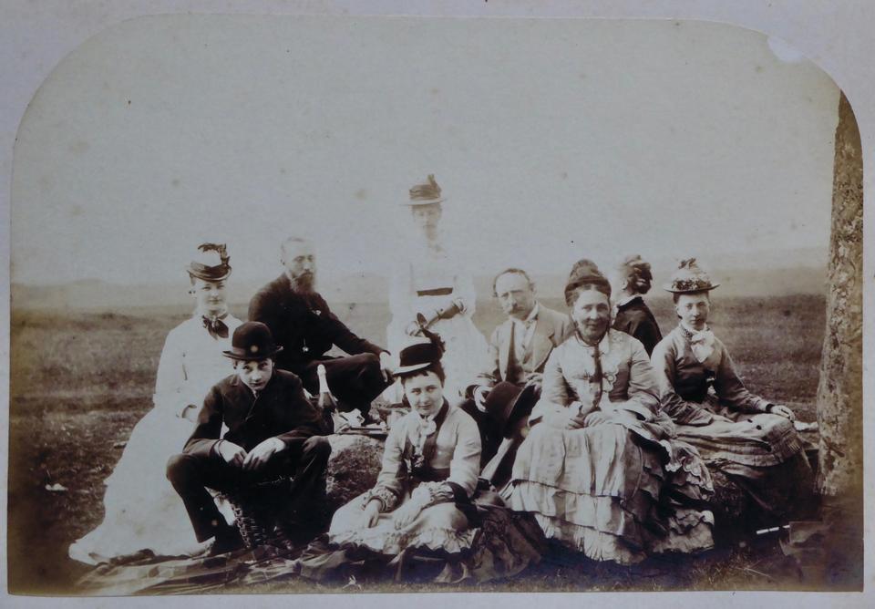 The family on a picnic rug at Stonehenge