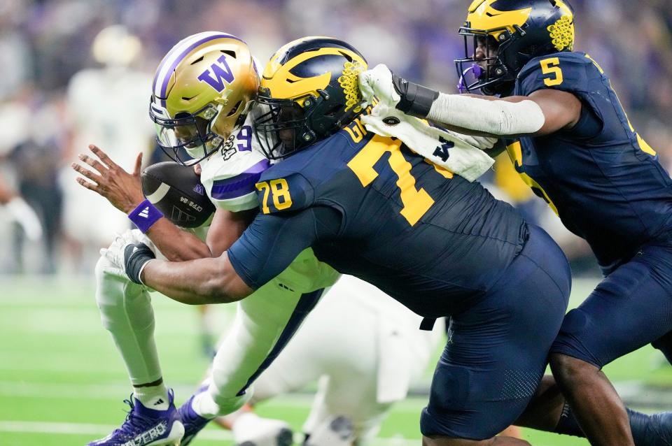 Michigan defensive lineman Kenneth Grant sacks Washington quarterback Michael Penix Jr. during the second quarter. It was a long night for Penix, who had picked apart the Texas defense one week earlier in the Sugar Bowl.