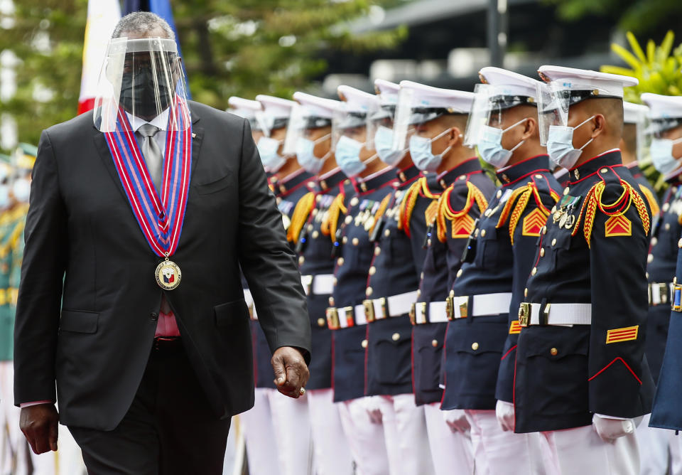 United States Defense Secretary Lloyd Austin views the military honor guard at Camp Aguinaldo military camp in Quezon City, Metro Manila, Philippines Friday, July 30, 2021. Austin is visiting Manila to hold talks with Philippine officials to boost defense ties and possibly discuss the The Visiting Forces Agreement between the US and Philippines. (Rolex dela Pena/Pool Photo via AP)