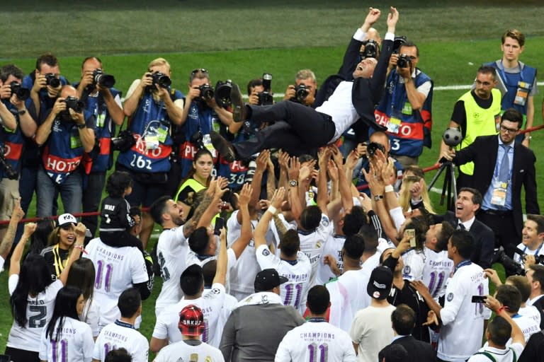 Real Madrid coach Zinedine Zidane is lifted by his players after they won the UEFA Champions League final against Atletico Madrid