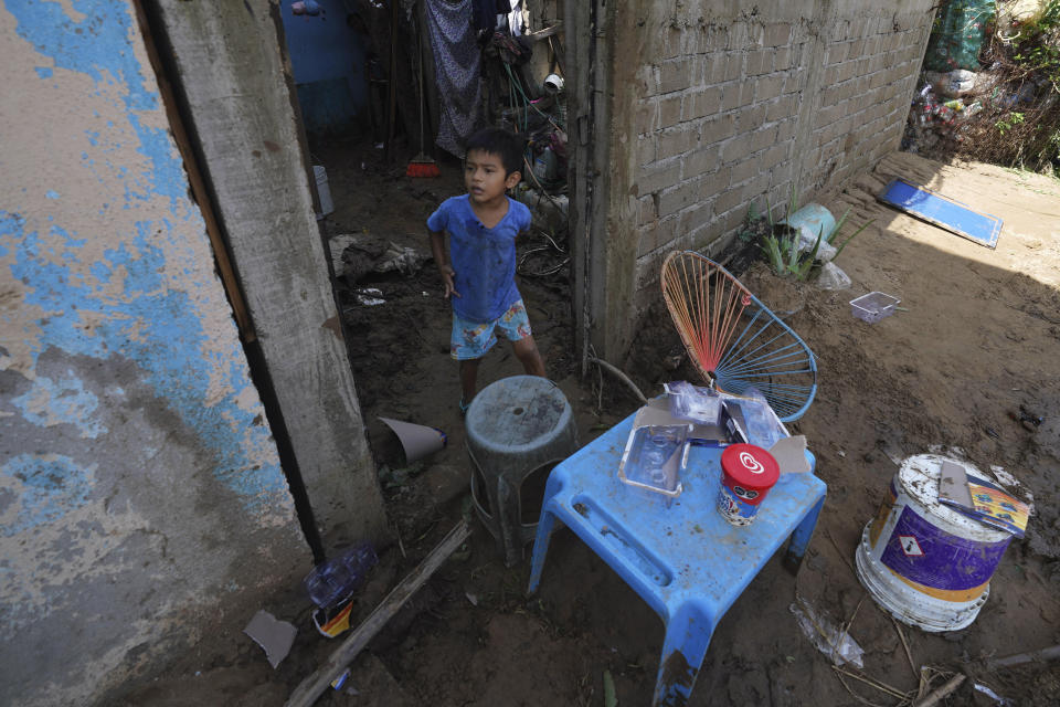 A child stands at the entrance of his damaged home after Hurricane Otis ripped through Acapulco, Mexico, Thursday, Oct. 26, 2023. The hurricane that strengthened swiftly before slamming into the coast early Wednesday as a Category 5 storm has killed at least 27 people as it devastated Mexico’s resort city of Acapulco. (AP Photo/Marco Ugarte)