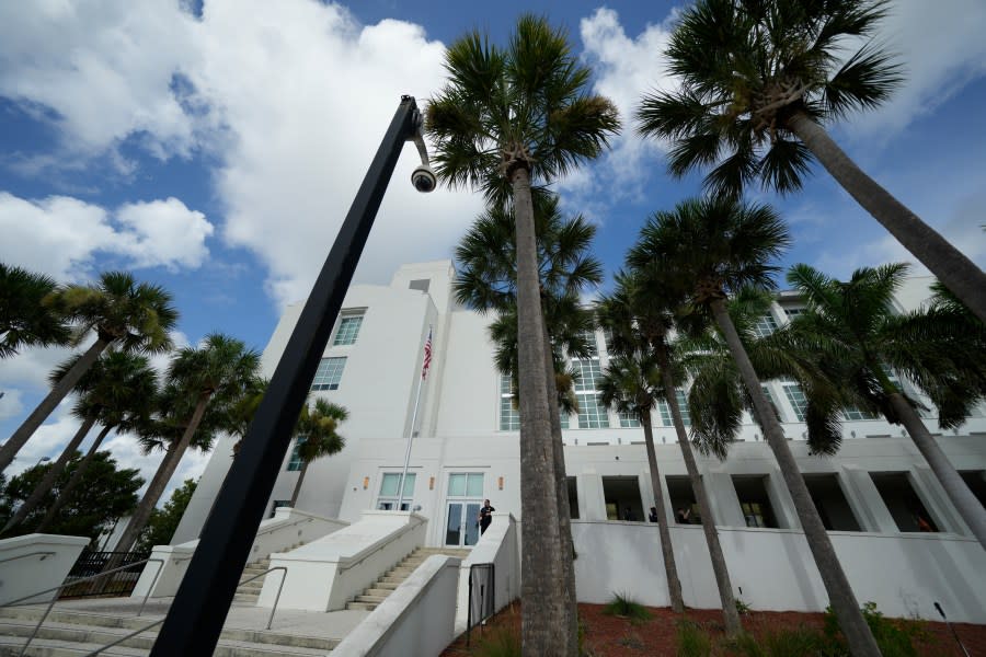 FILE – A police officer stands beside an entrance to the Alto Lee Adams Sr. U.S. Courthouse, Aug. 15, 2023, in Fort Pierce, Fla. The federal judge presiding over the classified documents case against former President Donald Trump is hearing arguments Friday, June 21, 2024, on a long-shot defense effort to get the indictment thrown out based on the claim that the prosecutor who brought the charges was illegally appointed. (AP Photo/Rebecca Blackwell, File)