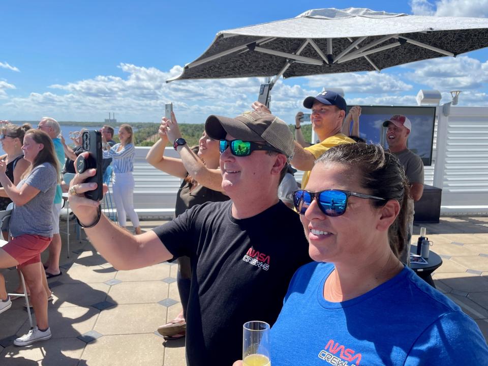 Mellisa and Mike Harris of Destin watch the NASA-SpaceX Crew-5 rocket take flight Wednesday during a party honoring mission commander Nicole Mann at The Space Bar in Titusville.