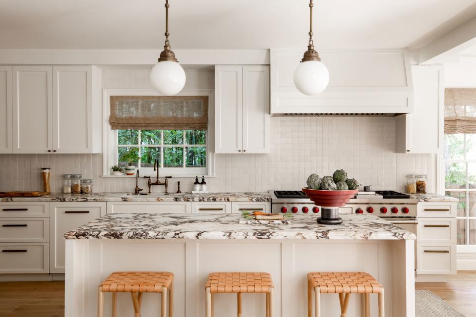 The footprint of the kitchen was kept roughly as it was when the current owners purchased the house, although a new worktop in luscious Calacatta Viola stone was added. Its burgundy tones pick up on other elements throughout the house, such as the curtains in the living room.