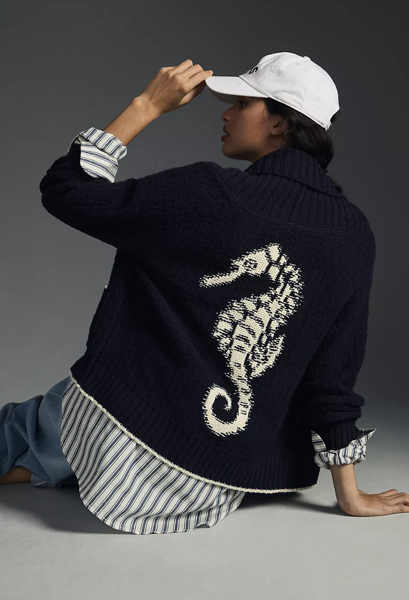 model wearing striped shirt, blue jeans and Maeve Seahorse Cardigan Sweater (photo via Anthropologie)