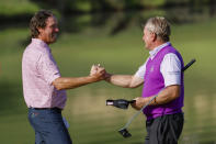 Stephen Ames shakes hands with Paul Broadhurst after finishing the final round of the Mitsubishi Classic senior golf tournament at TPC Sugarloaf, Sunday, April 28, 2024, in Duluth, Ga. (Miguel Martinez/Atlanta Journal-Constitution via AP)