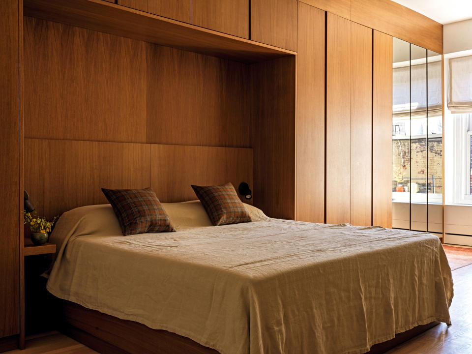 a bedroom with built-in storage over the bed