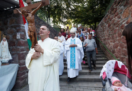 A bishop and priests arrive at a holy mass during a pilgrimage near the chapel in Csatka, Hungary on September 9, 2017. REUTERS/Laszlo Balogh