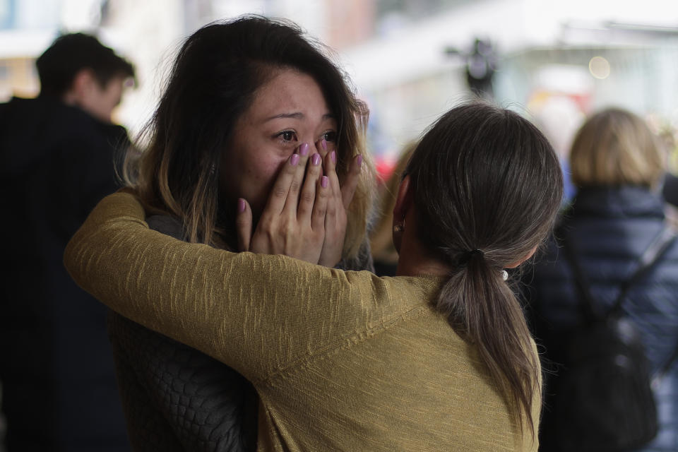 A woman cries as she stands in front of the reopened department store Ahlens in Stockholm, Sweden, Monday, April 10, 2017. Swedes questioned their country's welcoming immigration policies with pride and pain after learning that an asylum-seeker from Uzbekistan was allegedly behind the truck rampage that killed four people, Stockholm's deadliest extremist attack in years. (AP Photo/Markus Schreiber)