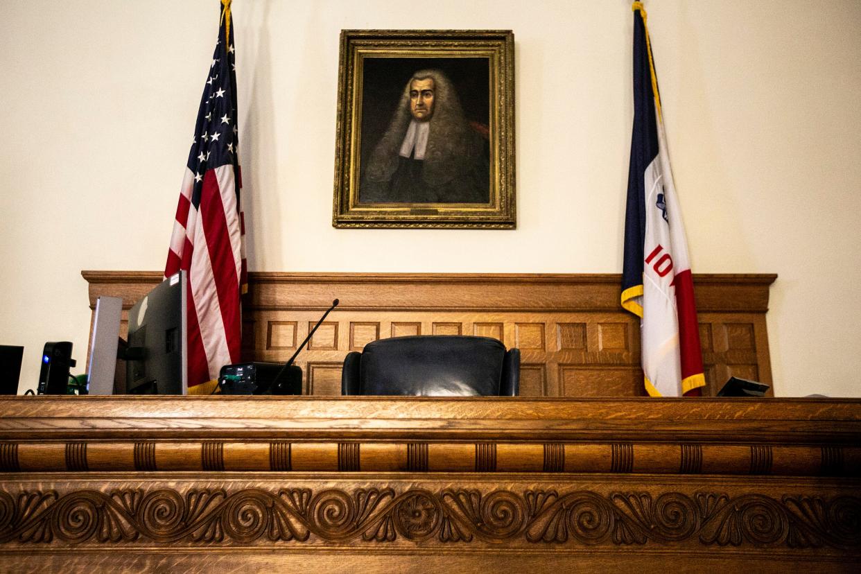 The flags of the United States and state of Iowa are seen flanking the judge bench in courtroom 3A, Friday, July 29, 2022, at the Johnson County Courthouse in Iowa City, Iowa. Tara Dutcher's case was moved upstairs to courtroom 3A early Tuesday after a large contingent of the public attended the first day of proceedings.