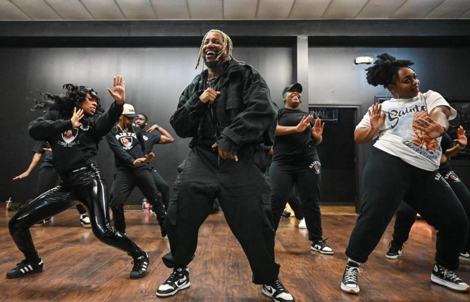 Dennis Reed Jr., center, rehearses with Sainted at a Charlotte dance studio last week. He co-founded the group — a “trap choir,” which performs an eclectic range of gospel, R&B, hip-hop and trap music — with DJ Fannie Mae.