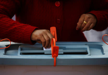 A woman cast her vote during the parliamentary and provincial elections in Thimi, Nepal December 7, 2017. REUTERS/Navesh Chitrakar