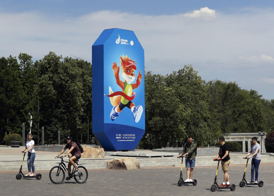 In this photo taken on Wednesday, June 19, 2019, people pass by advertisement billboard in Minsk, Belarus. Shrunken in size and struggling for attention, the European Games open Friday in Belarus which is one of the continent’s most isolated countries. There was a lavish inaugural event in Azerbaijan four years ago with the opening ceremony alone costing $95 million and starring Lady Gaga. But it wasn’t enough to attract many big-name athletes to Minsk for this year’s event. (AP Photo/Sergei Grits)