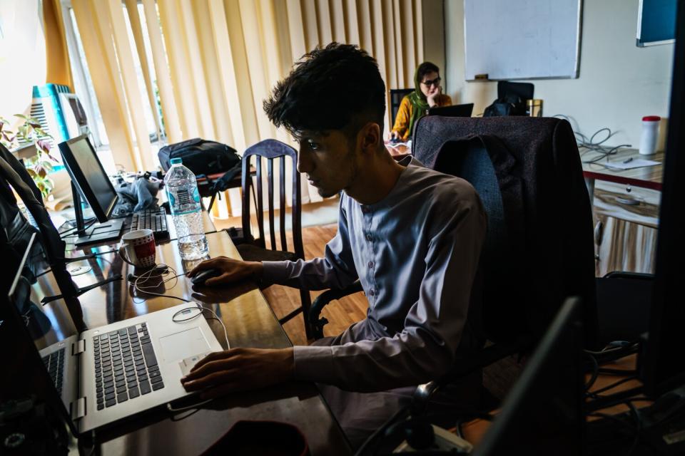 Video journalist working on his laptop