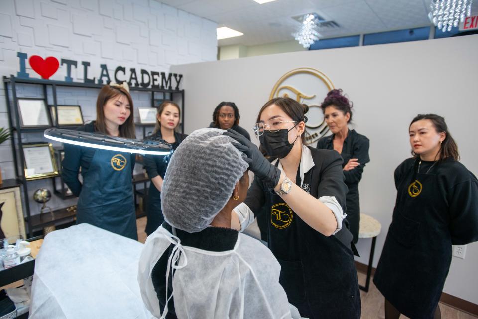 The Sexybrows class looks on as Trang Lu examines her work inside MT Salon in Jackson, Tenn., on Sunday, Oct. 15, 2023.