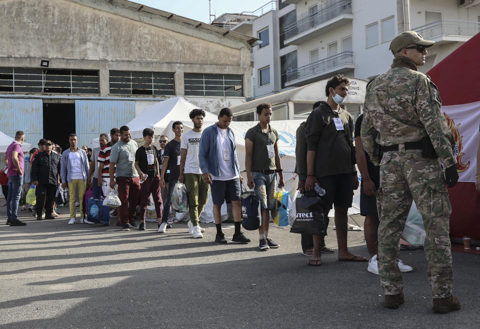 Survivors of latest tragical shipwreck prepare to board a bus to transfer to Athens at the port of Kalamata, Greece, Friday, June 16, 2023. The round-the-clock effort continued off the coast of southern Greece despite little hope of finding survivors or bodies after none have been found since Wednesday, when 78 bodies were recovered and 104 people were rescued. (John Liakos/InTime News via AP)