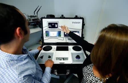 Alexandra Schaefer, head of the SmartCore-Center of Competence and her colleague Hector Zarate of U.S. automotive supplier Visteon work on a set-up to demonstrate their new 'SmartCore' dashboard at the companies technical center in Karlsruhe, Germany June 23, 2017. Picture taken June 23, 2017. REUTERS/Ralph Orlowski