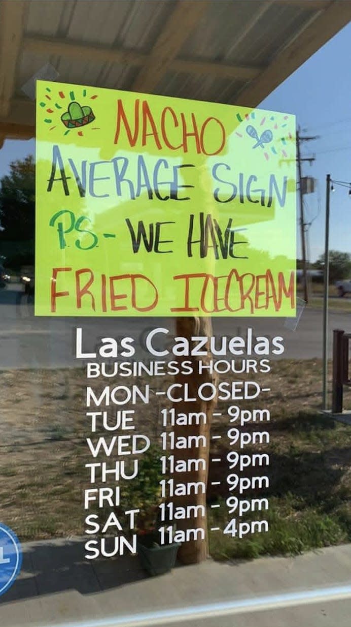a sign from Las Cazuelas Mexican restaurant that says "Nacho average sign. PS we have fried ice cream"