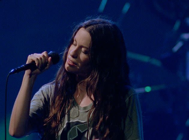 Alanis Morissette performing onstage during the Jagged Little Pill tour in 1996. (Photo: Photograph by Epiphany Music/Alanis Morissette/Courtesy HBO)