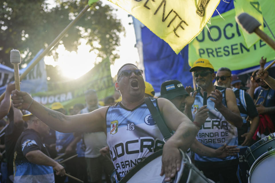 Supporters of Economy Minister Sergio Massa, presidential candidate for the ruling Union for the Homeland coalition, play drums outside his election night campaign headquarter after polls closed in the presidential runoff election in Buenos Aires, Argentina, Sunday, Nov. 19, 2023. (AP Photo/Matias Delacroix)