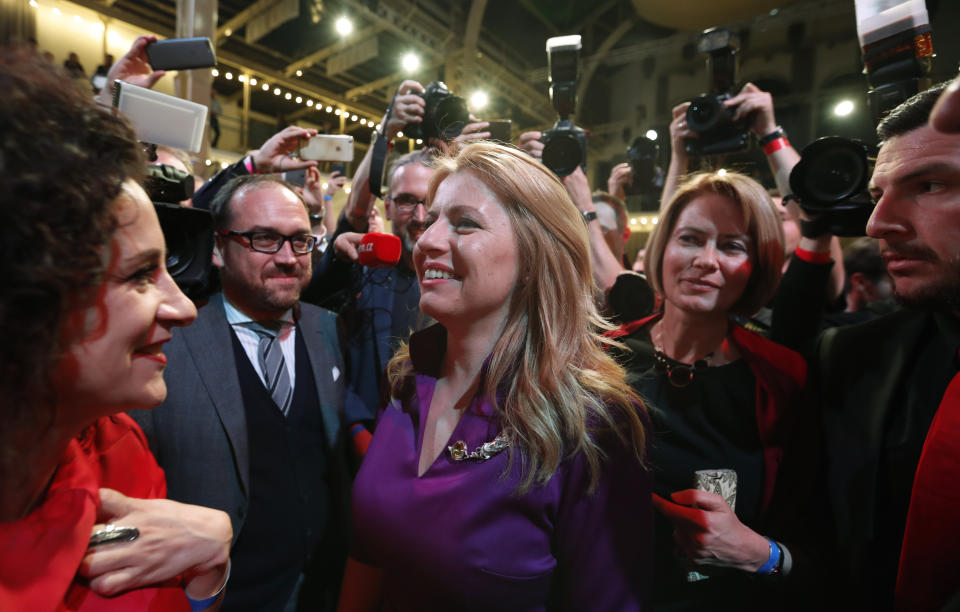 Presidential candidate Zuzana Caputova greets with supporters after acknowledging the first preliminary results of the second round of the presidential election in Bratislava, Slovakia, Saturday, March 30, 2019. Voting has ended in the runoff of Slovakia's presidential election, and early results show a favorite female candidate in a lead. (AP Photo/Petr David Josek)