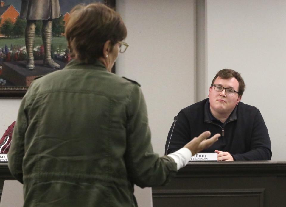 A resident speaks out against the Miller's Landing subdivision Thursday as Stow City Councilman Matt Riehl listens.