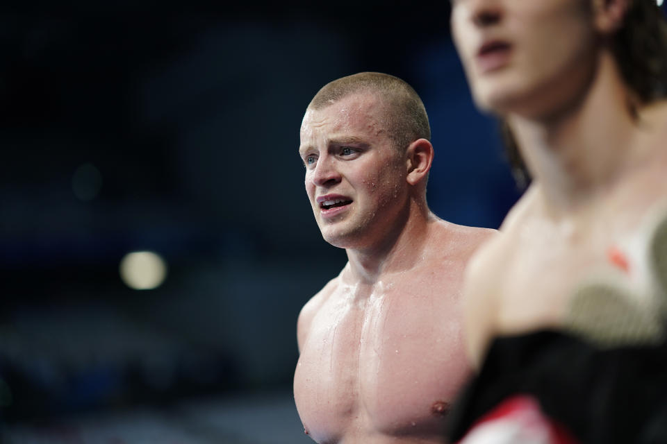 FILE - Britain's Adam Peaty leaves the pool after his team finished second in the mixed 4x100-meter medley relay at the 2020 Summer Olympics, Sunday, Aug. 1, 2021, in Tokyo, Japan. Peaty is taking an extended break to deal with mental health issues. Some of the world's greatest swimmers will miss the world championships as they deal with burnout and the enormous toll that their sport takes on their minds and bodies. (AP Photo/David Goldman, File)