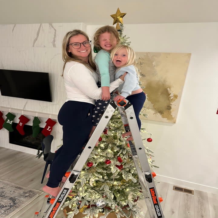 the author and her daughters decorating the Christmas tree