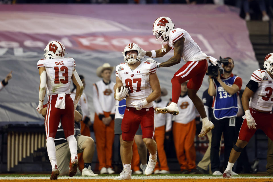 PHOENIX, ARIZONA – DECEMBER 27: Wide receiver Skyler Bell #11 of the Wisconsin Badgers reacts with tight end Hayden Rucci #87 after Rucci scored a touchdown during the first half of the Guaranteed Rate Bowl against the Oklahoma State Cowboys at Chase Field on December 27, 2022 in Phoenix, <a class="link " href="https://sports.yahoo.com/ncaaf/teams/arizona-st/" data-i13n="sec:content-canvas;subsec:anchor_text;elm:context_link" data-ylk="slk:Arizona;sec:content-canvas;subsec:anchor_text;elm:context_link;itc:0">Arizona</a>. (Photo by Chris Coduto/Getty Images)