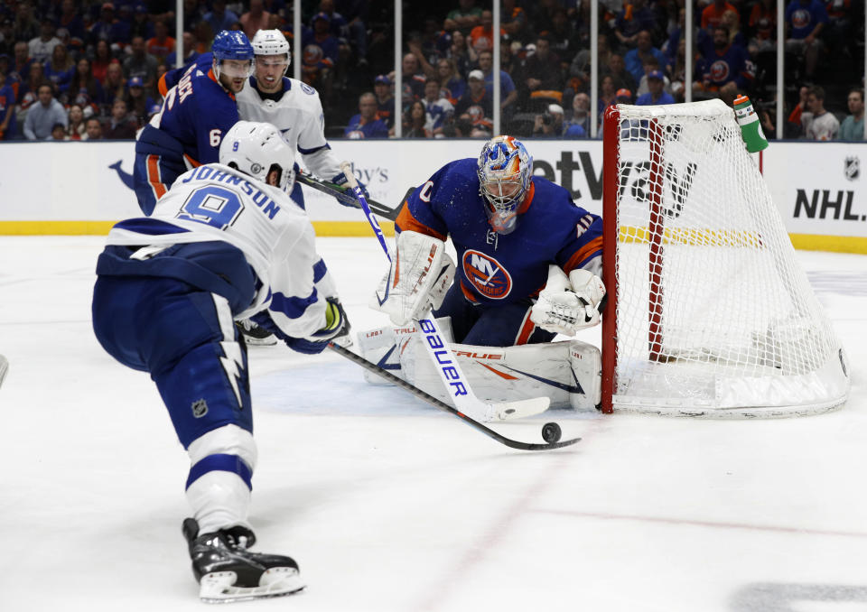 New York Islanders goaltender Semyon Varlamov (40) defends against a shot by Tampa Bay Lightning center Tyler Johnson (9) during the third period in Game 4 of an NHL hockey Stanley Cup semifinal, Saturday, June 19, 2021, in Uniondale, N.Y. (AP Photo/Jim McIsaac)