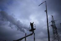 Electrician worker checks damages at a power plant after a rocket attack in Kyiv, Ukraine, Thursday, Jan. 26, 2023. (AP Photo/Daniel Cole)